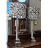 TABLE LAMPS, a pair, polished metal column design, black and white foliate print shades, 81cm H x