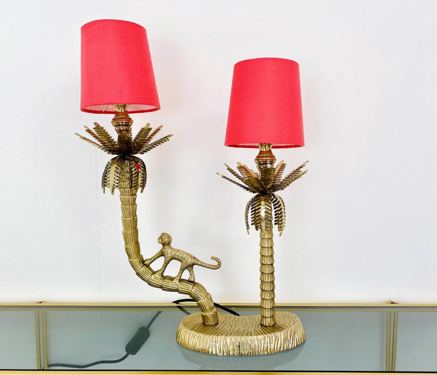 TABLE LAMP, two branch, gilt metal, in the form of a monkey climbing trees, with shades, 50cm x 32cm