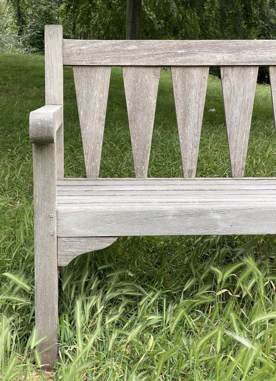 GARDEN BENCH, weathered teak with triangular slatted back and scroll arms, 137cm W. - Image 7 of 9