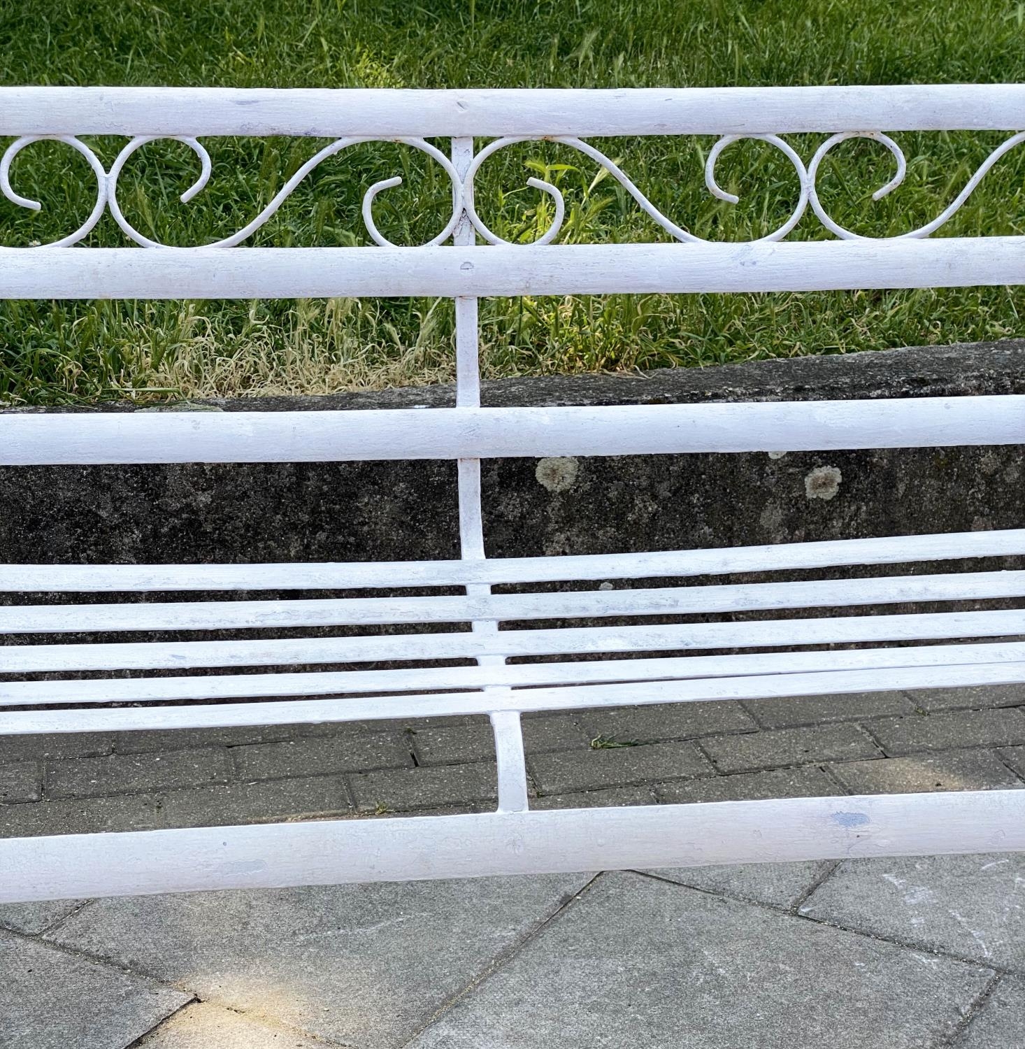 GARDEN BENCH, antique wrought iron and white painted with slatted back and seat and scroll arms, - Image 4 of 6
