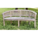 BANANA GARDEN BENCH, weathered teak with curved back and slatted construction, 150cm W.