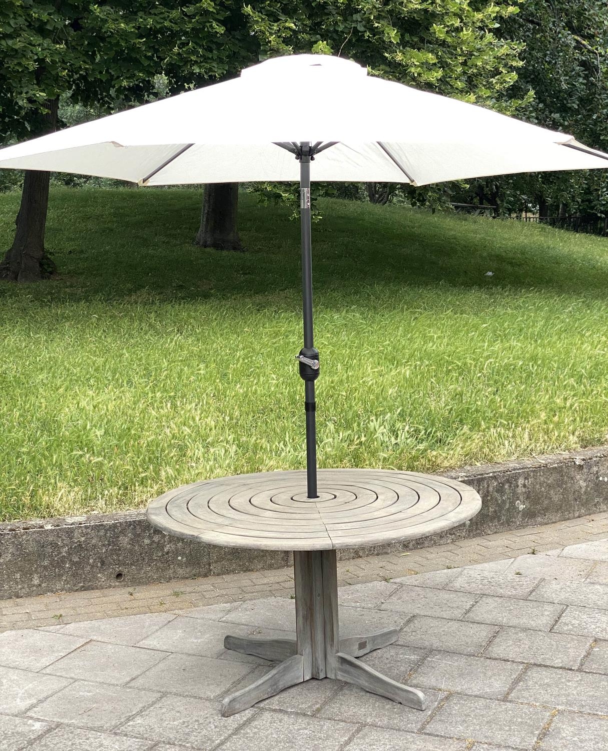 CIRCULAR GARDEN TABLE, weathered teak with circular concentric slatted top and centre column support