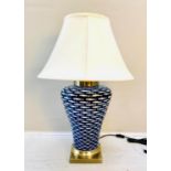 TABLE LAMP, 74cm high, 50cm diameter, blue and white ceramic with fish design, shade.