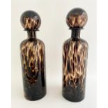DECANTERS, a pair, 40cm high, 10cm diameter, Murano style tortoiseshell glass, cylindrical form. (2)