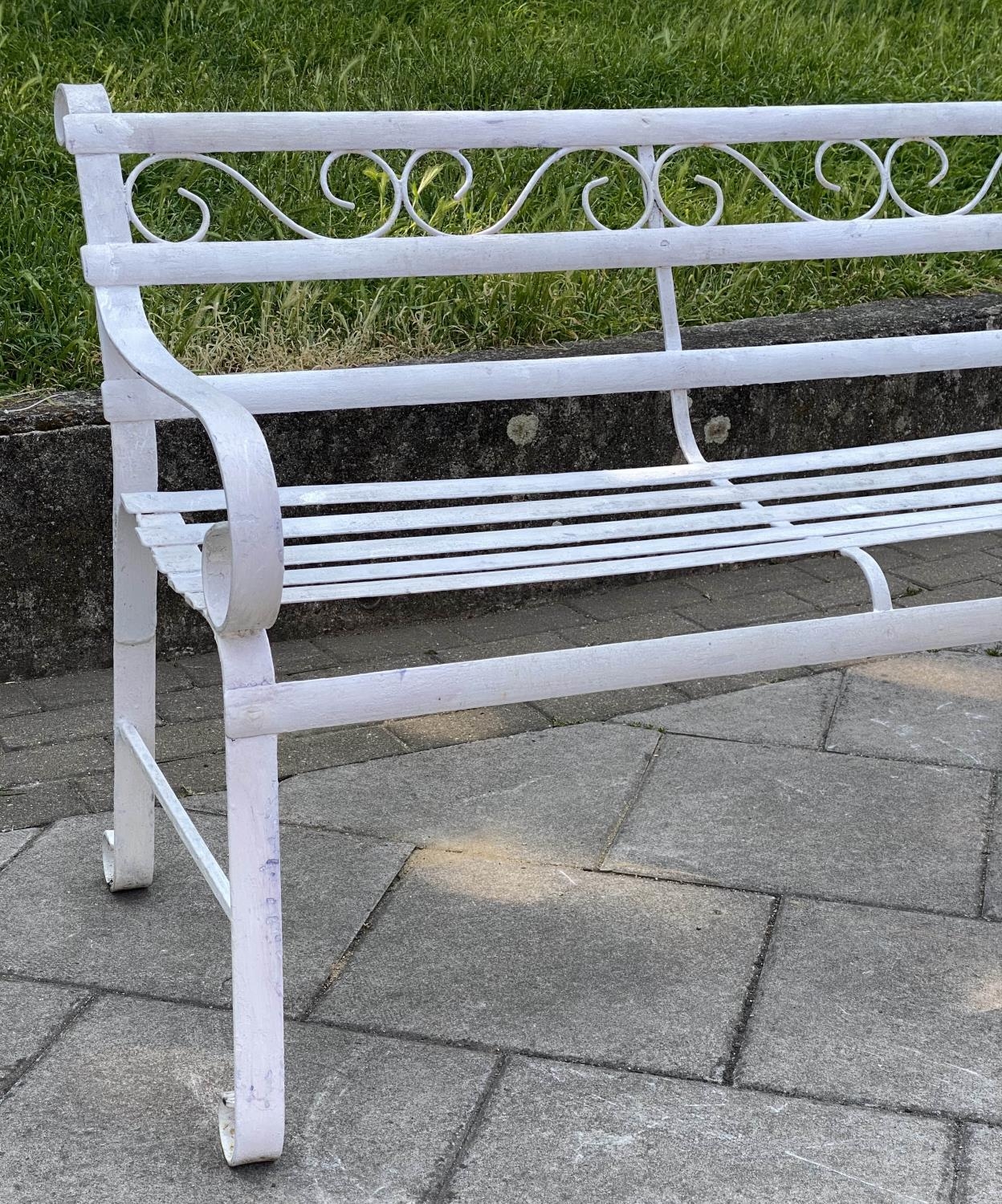 GARDEN BENCH, antique wrought iron and white painted with slatted back and seat and scroll arms, - Image 3 of 6