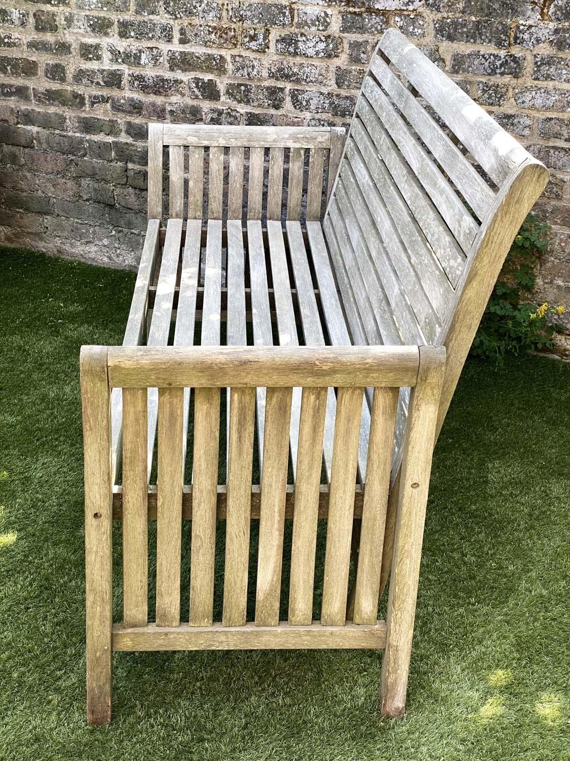 GARDEN BENCH, weathered teak with horizontal slat back and seat and downswept arms by 'Trinity', - Image 2 of 4