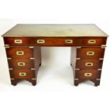 PEDESTAL DESK, Campaign style mahogany with brass mounts and nine drawers, 75cm H x 122cm x 54cm.