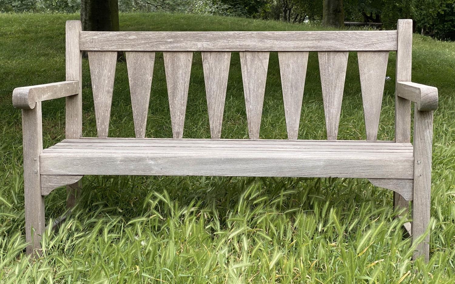 GARDEN BENCH, weathered teak with triangular slatted back and scroll arms, 137cm W.