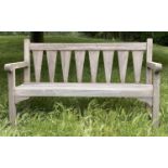 GARDEN BENCH, weathered teak with triangular slatted back and scroll arms, 137cm W.