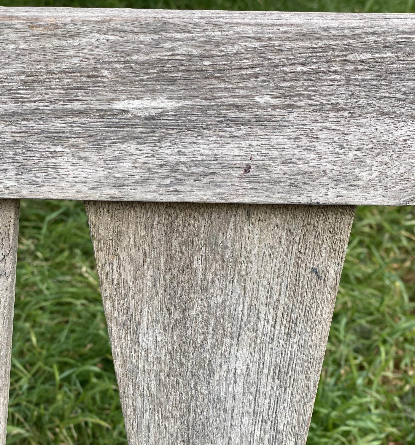 GARDEN BENCH, weathered teak with triangular slatted back and scroll arms, 137cm W. - Image 6 of 9