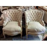 BERGERES, a pair, deep buttoned backs, cream upholstery, French style, 93cm H x 73cm x 65cm. (2)