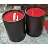 SIDE TABLES, a pair, 40cm diam x 56cm H, dark wood, red glass tops on castors. (2)