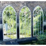 ARCHITECTURAL GARDEN MIRRORS, a set of three, 160cm high, 67cm wide, Gothic arched, aged metal