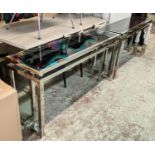 CONSOLE TABLES, a pair, 160cm x 45cm x 77cm, polished metal and smoked glass. (2)