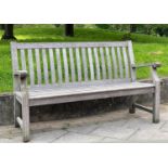 GARDEN BENCH, silvery weathered teak of slatted and pegged construction, 152cm W.