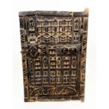 DOGON GRANARY DOOR, Mali, with symbolic raised carved decoration, 65cm H x 43cm W.