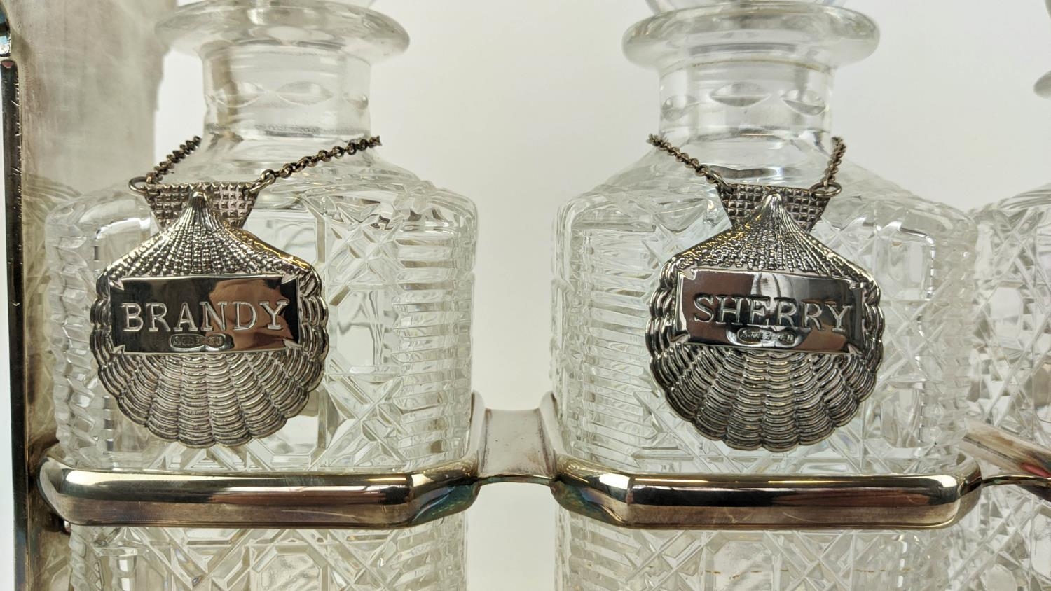 A WALKER AND HALL SILVER PLATED TANTALUS fitted with three square cut glass decanters, carrying - Image 4 of 11