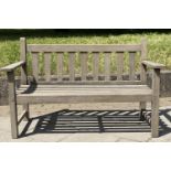 GARDEN BENCH, weathered teak with triangular splat back, 140cm W.