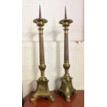 PRICKET CANDLESTICKS, a pair, each 98cm tall, brass Ecclesiastical style. (2)