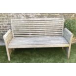 GARDEN BENCH, weathered teak with horizontal slat back and seat and downswept arms by 'Trinity',