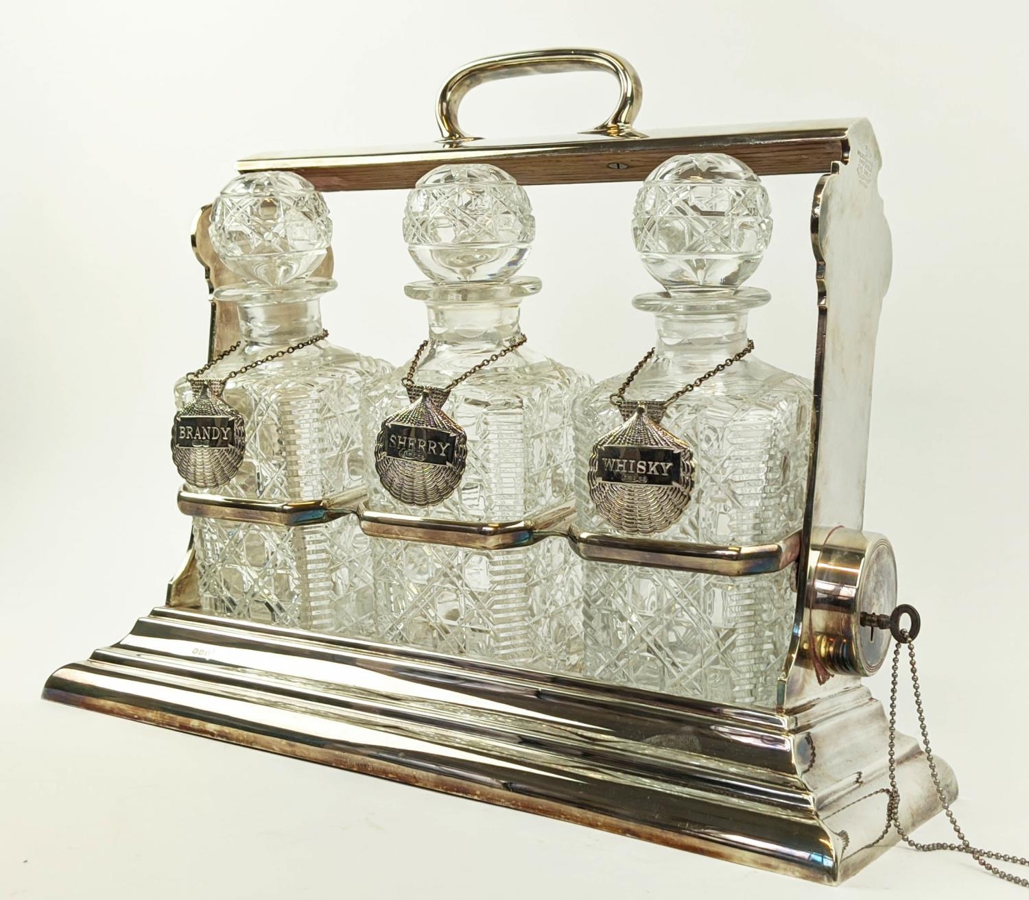 A WALKER AND HALL SILVER PLATED TANTALUS fitted with three square cut glass decanters, carrying - Image 8 of 11