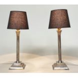 TABLE LAMPS, a pair, silvered each with Corinthian capped reeded column with shades, 50cm H. (2)