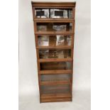 GLOBE WERNICKE BOOKCASE, early 20th century oak comprising seven graduated glazed sections with