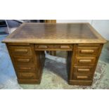 DESK, 77cm H x 122cm W x 80cm D, circa 1925 oak with two slides and eight drawers.