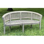 BANANA BENCH, silvery weathered teak with arched back and arms of slatted construction, 160cm W.