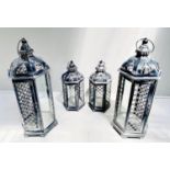 STORM LANTERNS, two graduated pairs, largest measuring 63cm high, 26cm diameter, painted metal. (4)