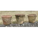 GARDEN TERRACOTTA PLANTERS, a set of three, large weathered terracotta with fruit decoration, 57cm W