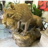 TIGER, of large proportions, carved wood with brass cladding mounted on rock effect base, 245cm L