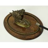 A WALL MOUNTED RIDING GRIP HOOK, cast bronze bust of a horse, oak plaque, 19th/early 20th century