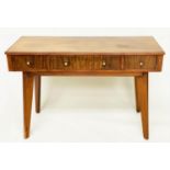 WRITING TABLE, 1970s teak and Indian laurel with three frieze drawers and tapering out swept