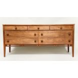 LOW CHEST, mid 20th century teak with seven drawers in the manner of Heals, 148cm x 69cm H x 46cm.