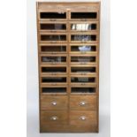 HABERDASHERY CABINET, mid 20th century oak with sixteen glass fronted drawers above four short