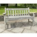 LISTER GARDEN BENCH, silvery weathered teak of slatted construction with flat top arms by R A Lister