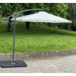 GARDEN PARASOL, circular cream canvas retractable wind up with frame and weights (water filled),