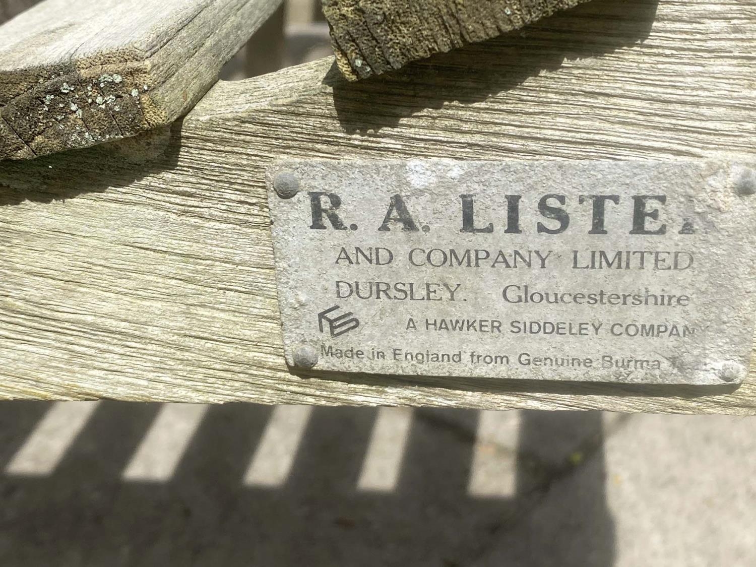 LISTER GARDEN BENCH, silvery weathered teak of slatted construction with flat top arms by R A Lister - Image 3 of 4