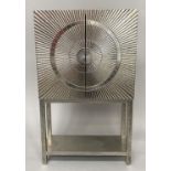 COCKTAIL CABINET, 1950s style silvered metal with pair of star burst doors and conforming stand,