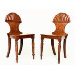 HALL CHAIRS, a pair, Regency mahogany with reeded arched back, panel seat and turned front supports,
