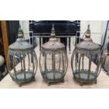 HANGING LANTERNS, set of three, antiqued copper finish, barrel form, glazed sides, 46cm H x 25cm