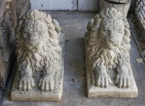 RECUMBENT LIONS, 50cm H x 33cm W, sold as a pair, reconstituted stone. (2)