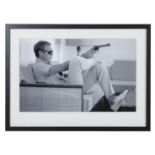 AFTER JOHN DOWNING, Steve McQueen with a gun, photographic print, framed and glazed, 54cm x 74cm.