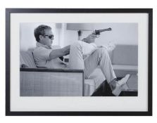 AFTER JOHN DOWNING, Steve McQueen with a gun, photographic print, framed and glazed, 54cm x 74cm.