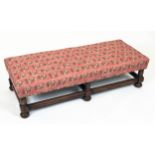 STOOL, 32cm H x 112cm W x 47cm D, Jacobean style oak, with pink floral patterned upholstery.