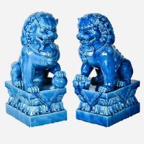 FOO DOGS, a pair, 39cm high, 15cm wide, 25cm deep, glazed ceramic. (2)