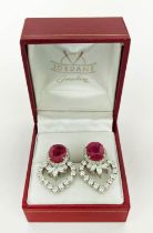 A PAIR OF 18CT WHITE GOLD RUBY AND DIAMOND EARRINGS, each set with a single natural oval mixed cut