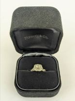 AN 18CT GOLD DIAMOND SET DRESS RING, the central princess cut diamond of approximately 0.25