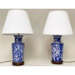 TABLE LAMPS, a pair, Chinese white on blue ceramic of ribbed vase form with birds and blossom,